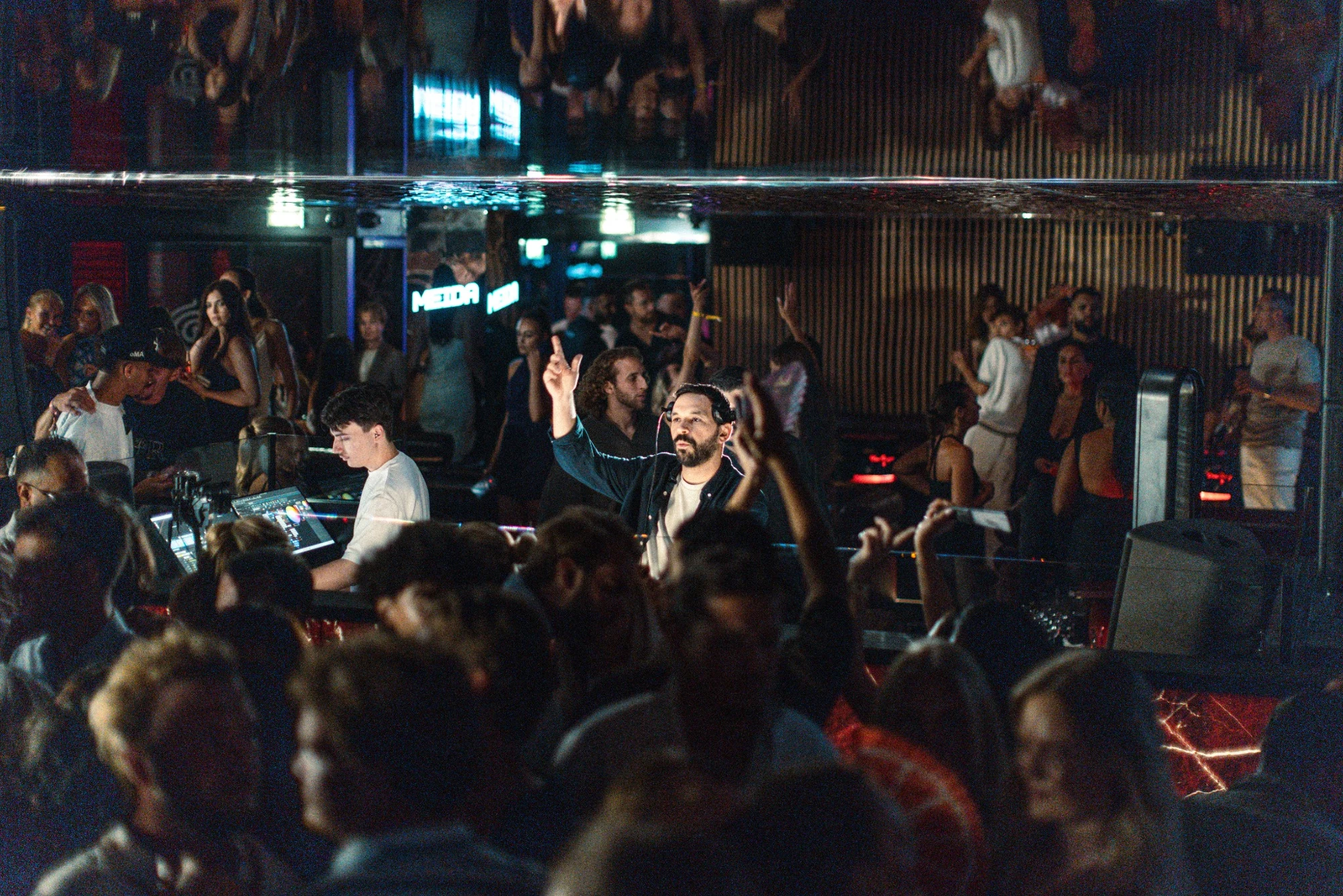 MEIDA raising his hands with the crowd at Baôli Cannes